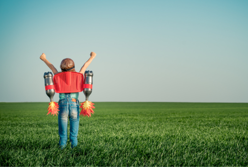 Kid with jetpack outdoors. Success, imagination and innovation technology concept. 